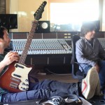 Tom and John laughing about guitars or something.